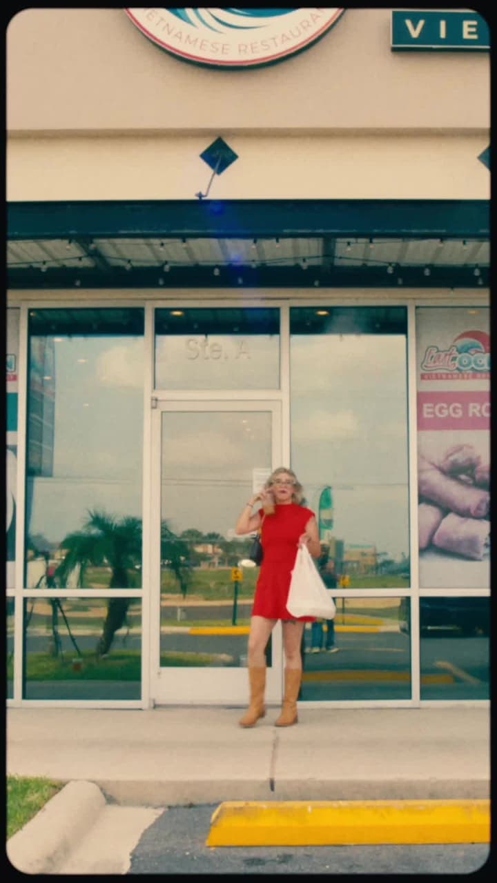 Woman in a red dress outside a boutique storefront