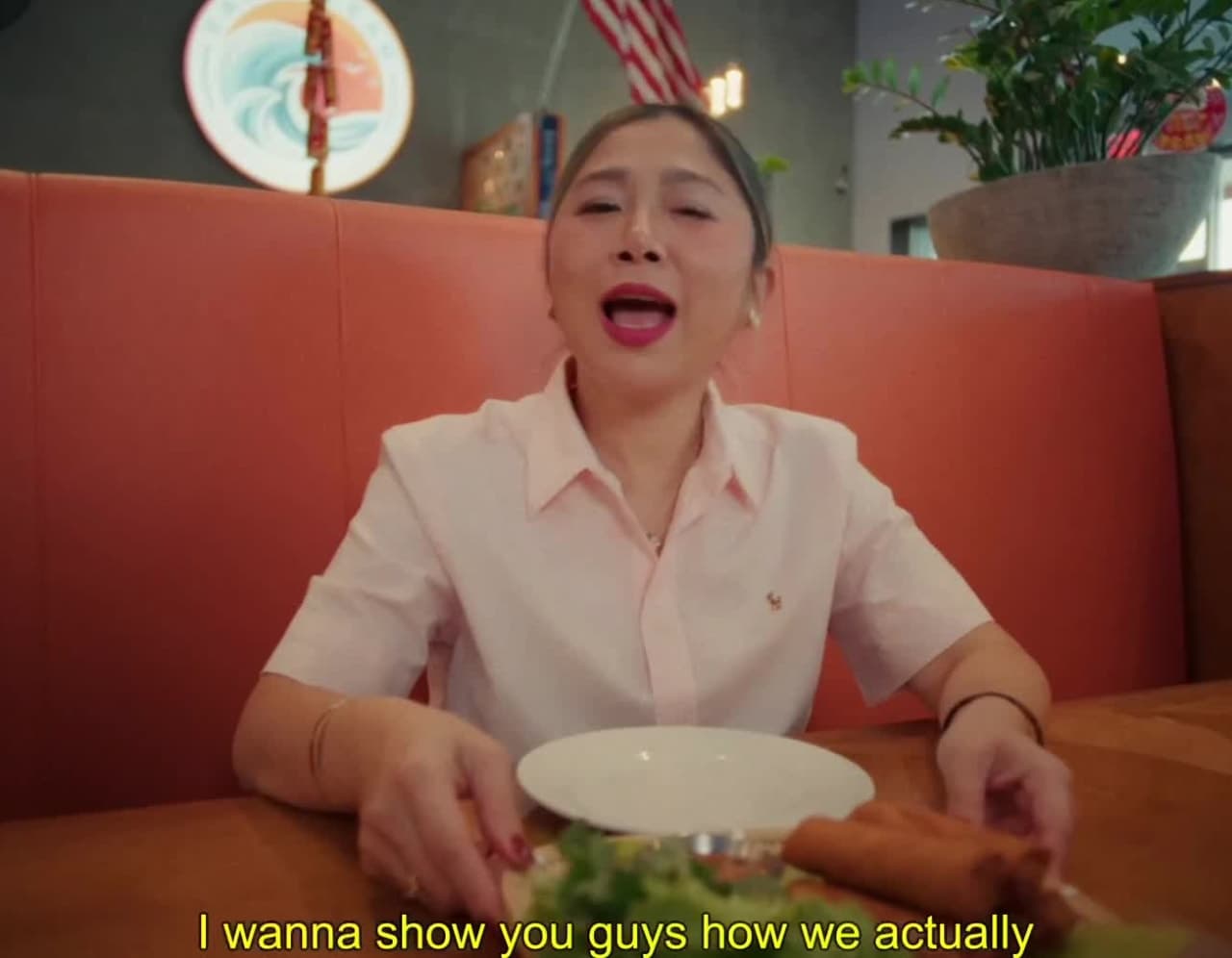 East Ocean Pho guest reacting in a red booth