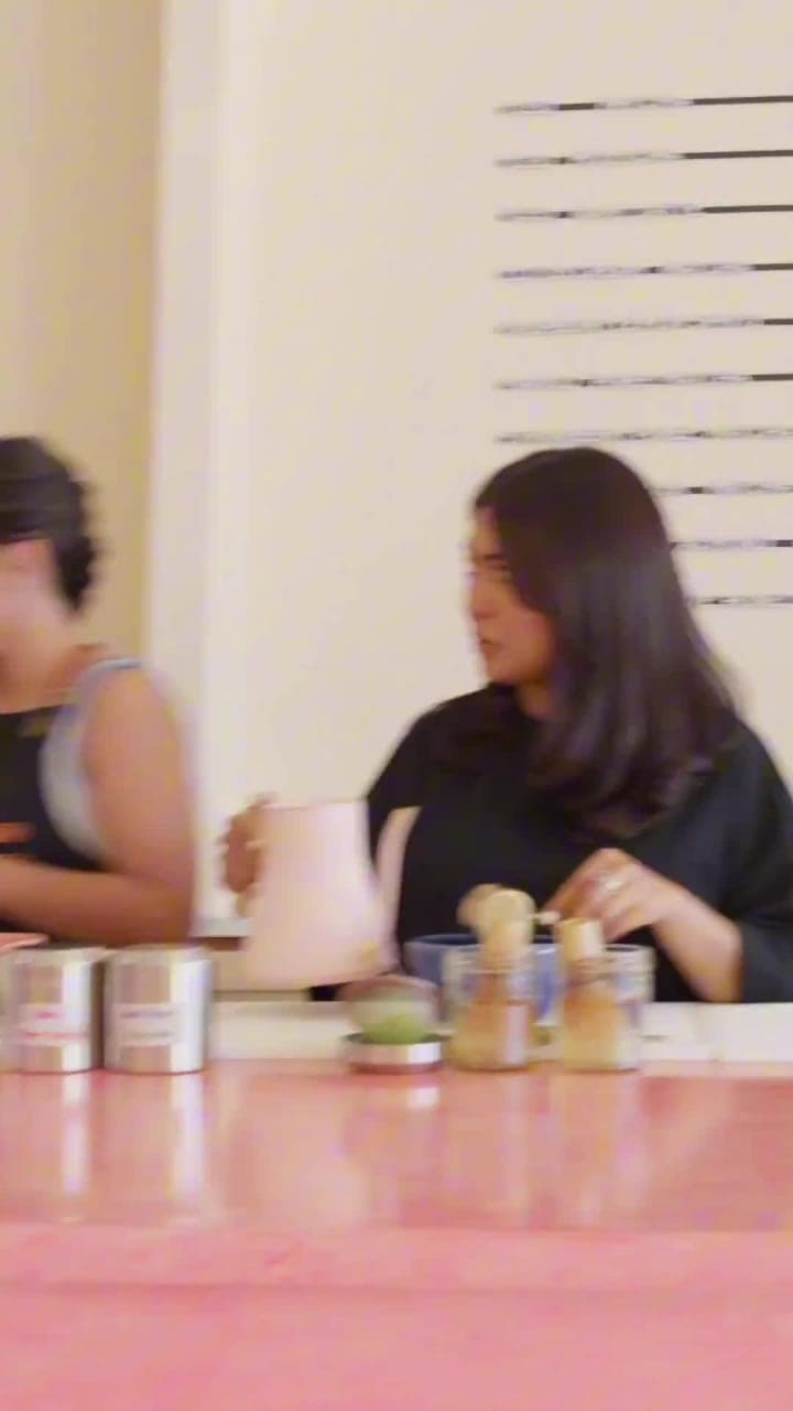 Two women talking across a café counter